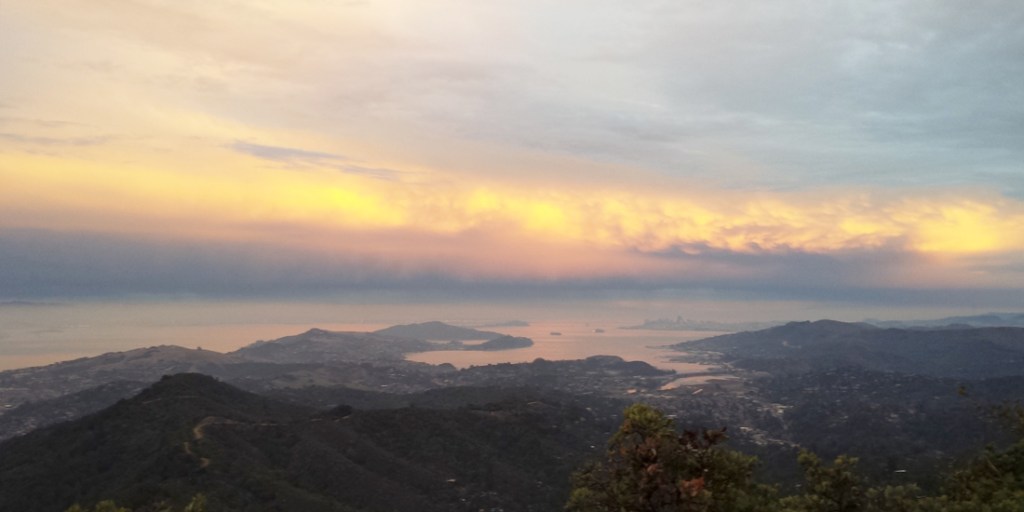 Golden clouds light up San Francisco and the Bay.