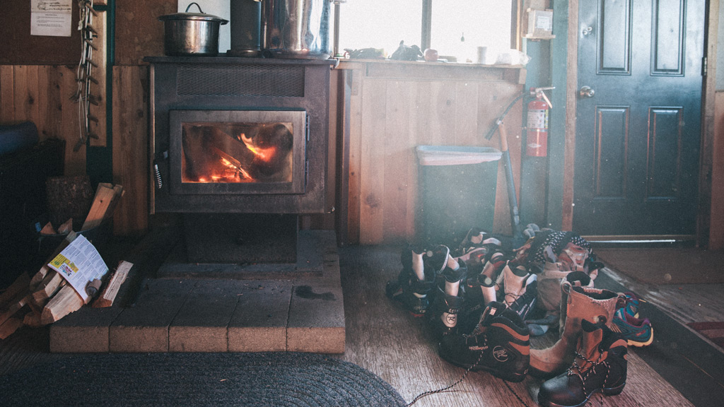 Interior of a ski cabin with a roaring fireplace