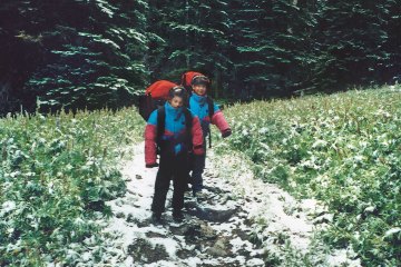 Two young children on a backpacking trip