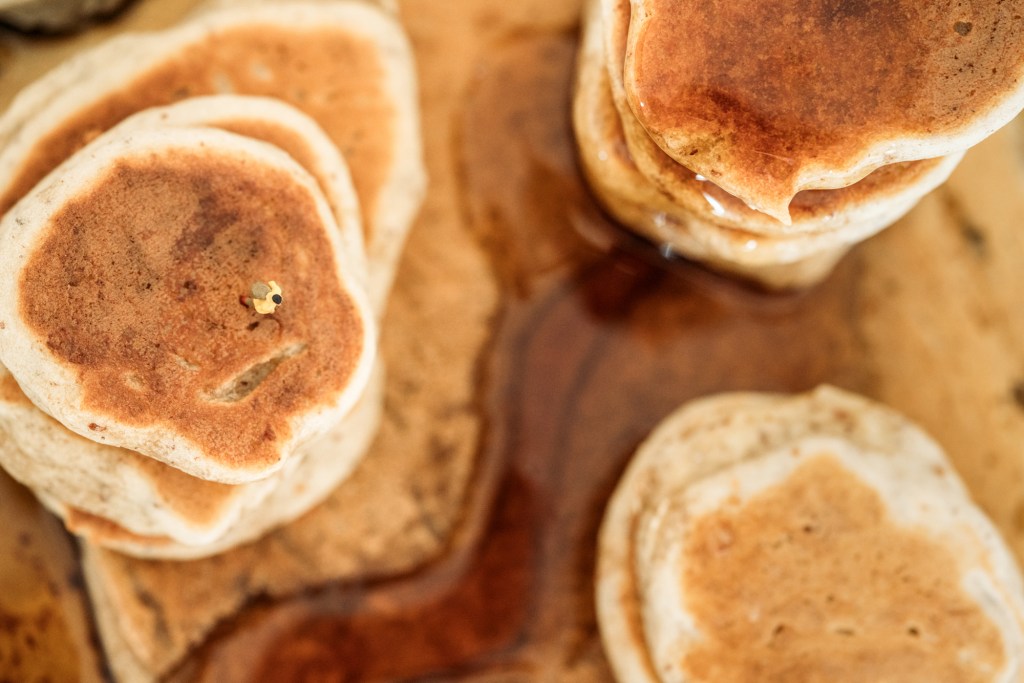 A tiny figurine stands above a canyon made of pancakes