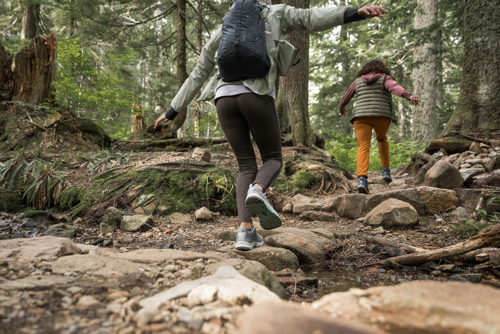 Two people hiking on rocks.