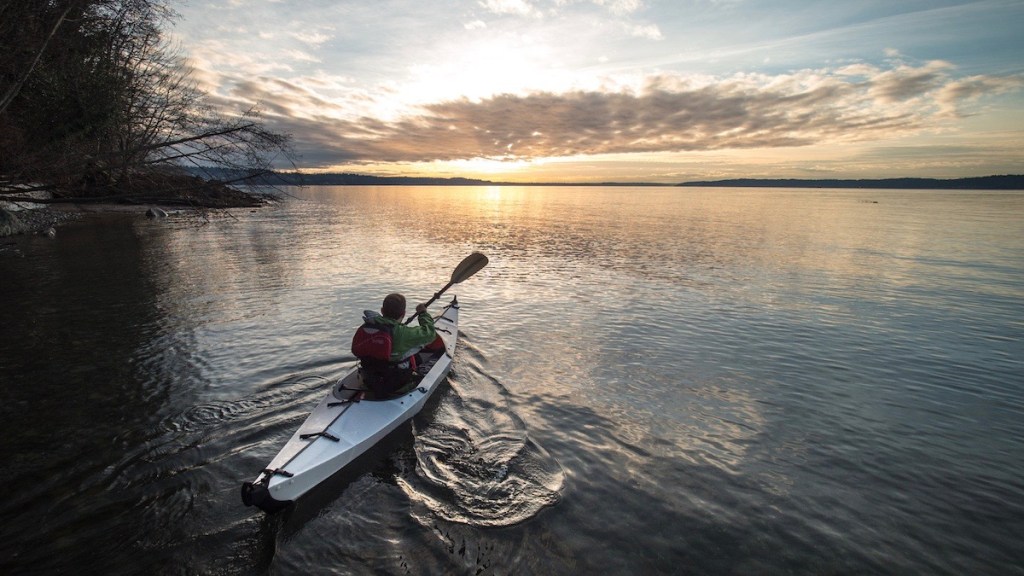 Man paddling on water.
