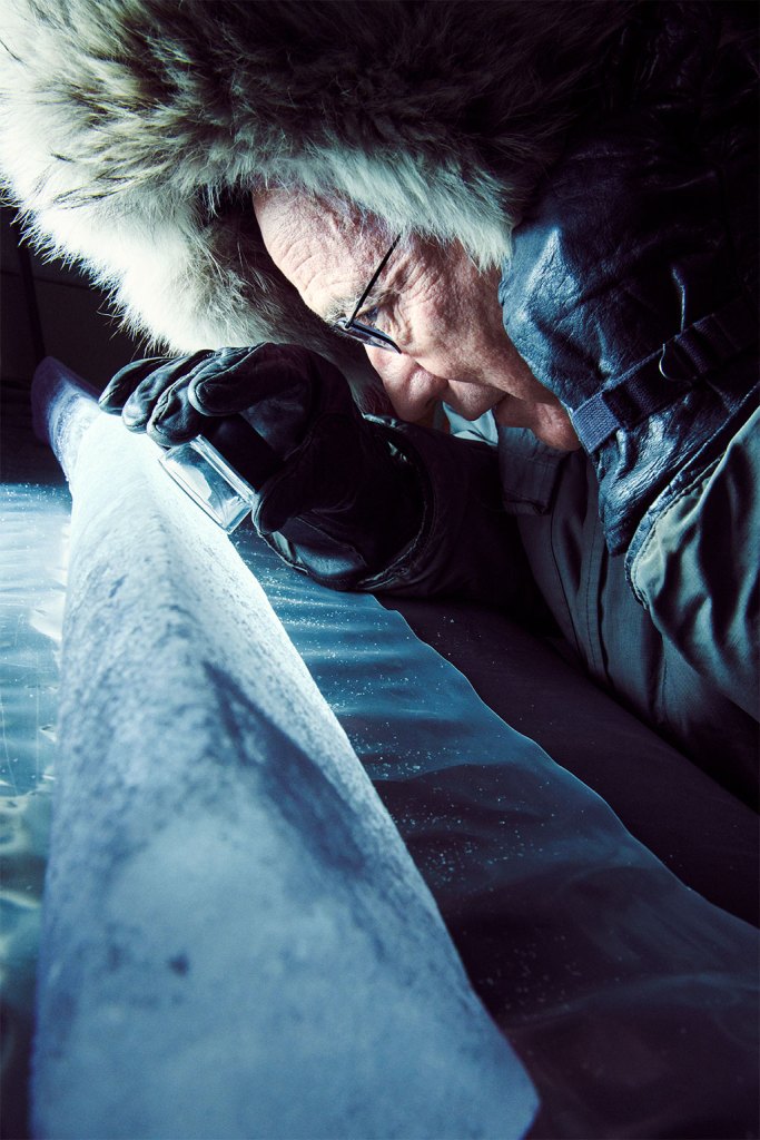 Thompson inspects an ice core from Tibet’s Puruogangri ice cap.