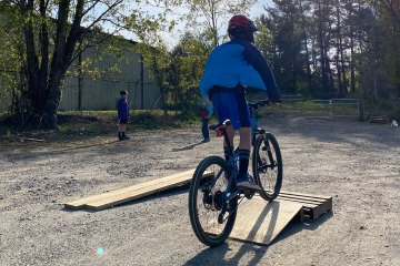 11-year-old on a bike going over a ramp