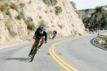 Amber Pierce riding her bike on a road.