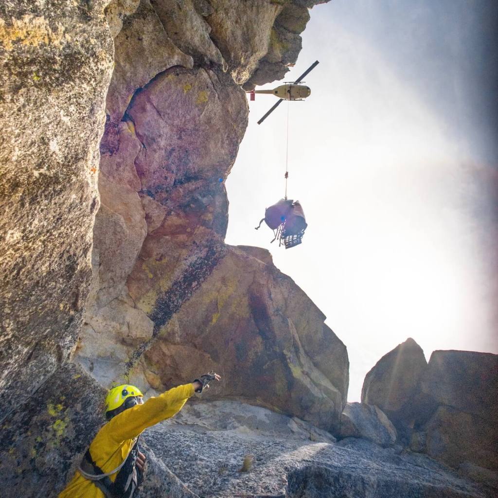 A search and rescue team begins setting up 1,200-foot lowering systems.