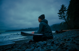 Chad Sayers sits on the beach looking out at the ocean.