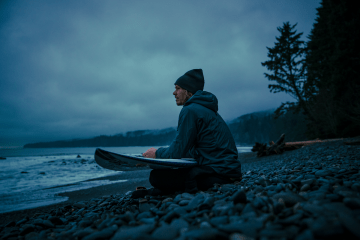 Chad Sayers sits on the beach looking out at the ocean.