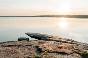 Sun setting over lake