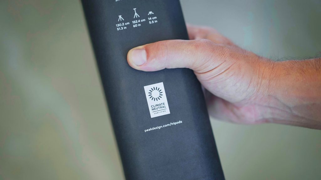 Person holding a product with climate neutral label.