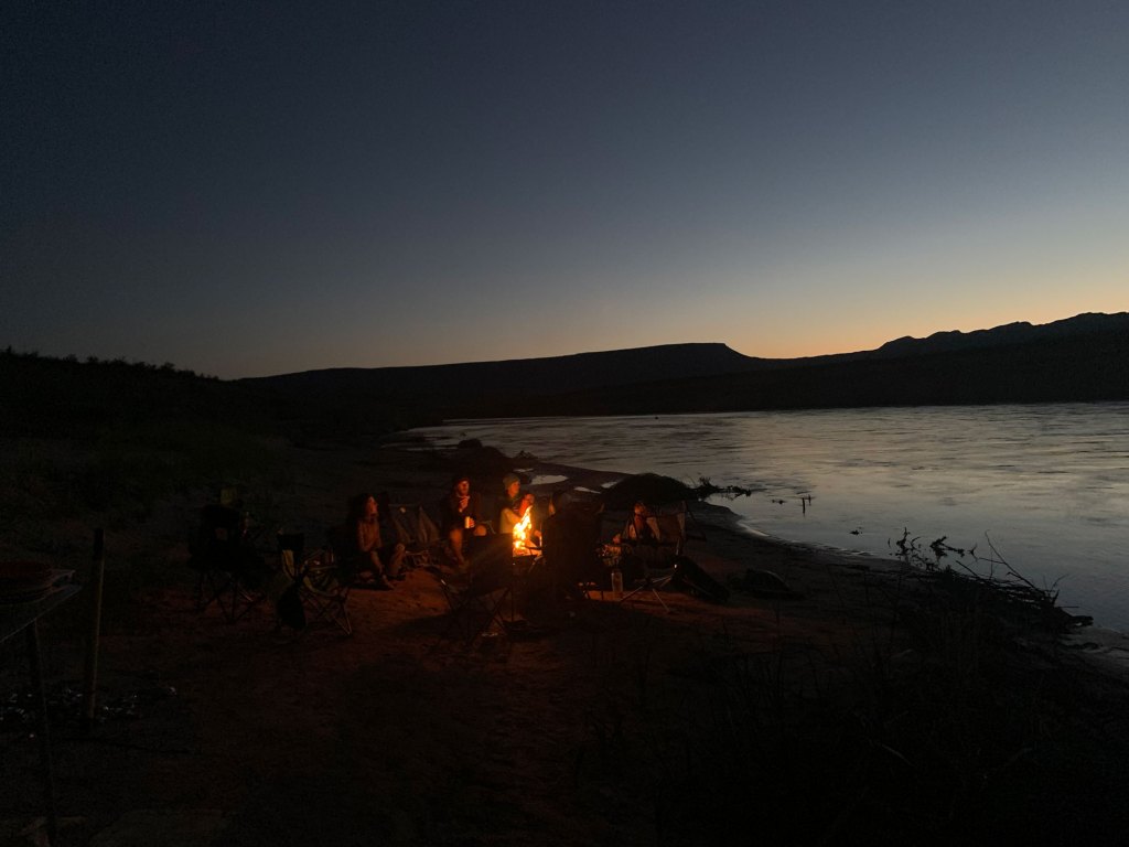 Paddlers sitting around a campfire