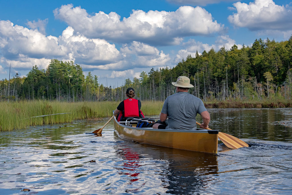 Two paddlers in a canoe in the Adirondacks region