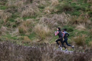 Two runners sprint uphill