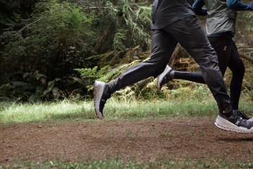 Two runners sprint down a trail in On shoes