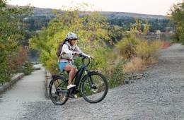 Person riding e-bike up hill