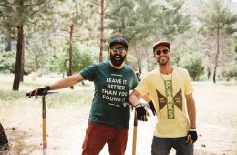 Parks Project founders, Sevag and Keith, have their hands on shovels and are smiling at the camera after working a trail maintenance day in the park.