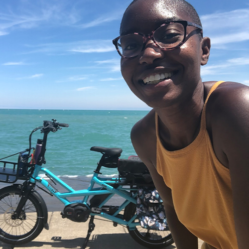 Woman in front of her blue e-bike