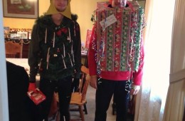 Two men dressed as holiday gifts.