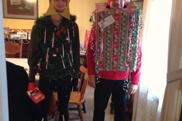 Two men dressed as holiday gifts.