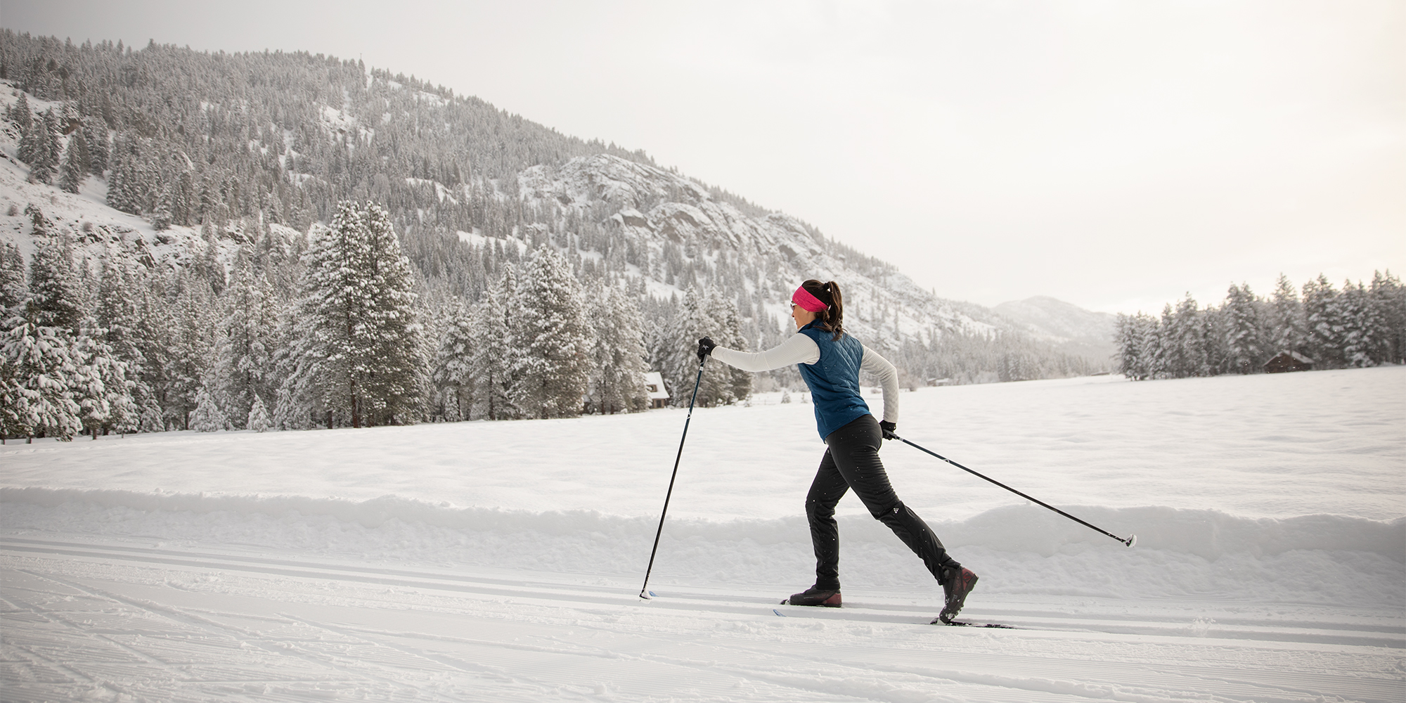 a cross-country skier skates on a groomed track