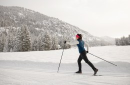 a cross-country skier skates on a groomed track