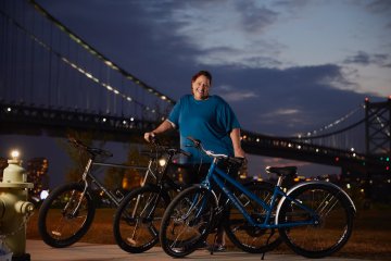 Person standing in front of three bikes during nighttime