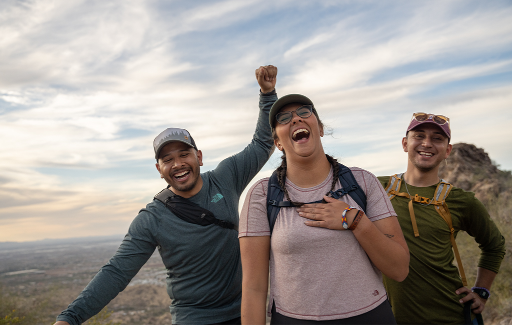 Three hikers laughing