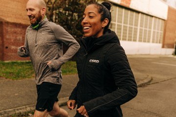 Ashley Davies running with a man next to her