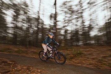 A person rides a bike in a wooded area near Atlanta