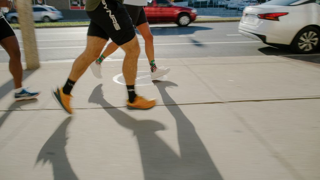 A shot of two runners from the waist down on a street