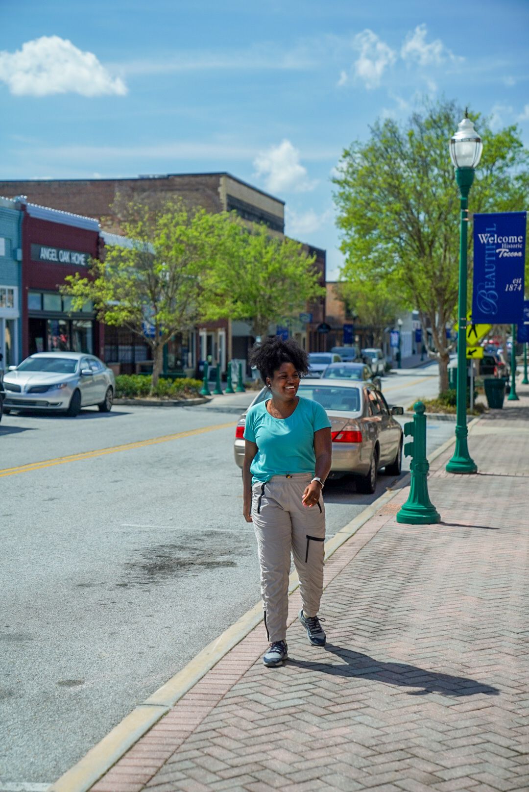 Tee George smiles as she walks down a street in town.