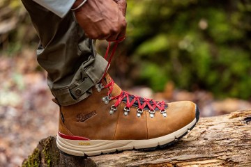 A hiker pauses to tie the laces on their Danner Mountain 600 Leaf GTX Hiking Boots