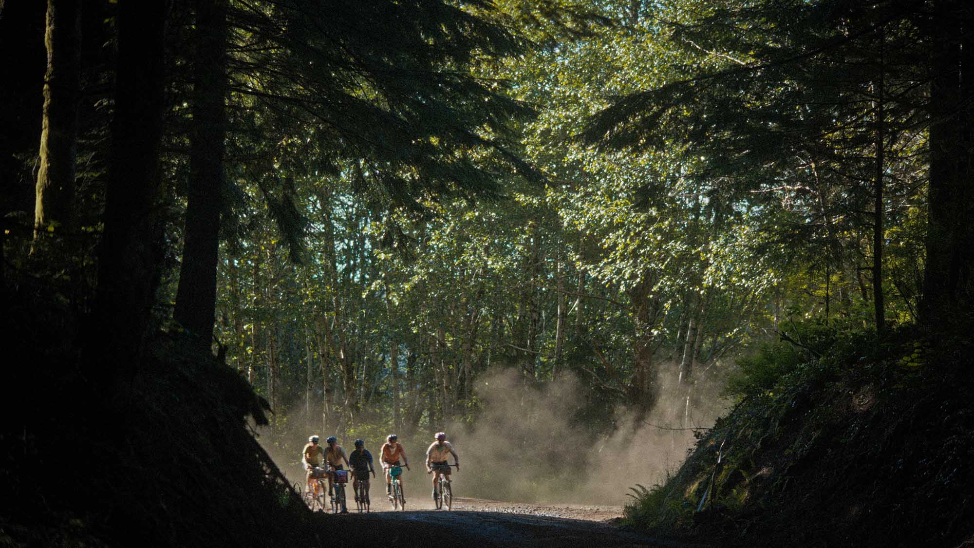 Izzy Sederbaum and friends bike on a trail