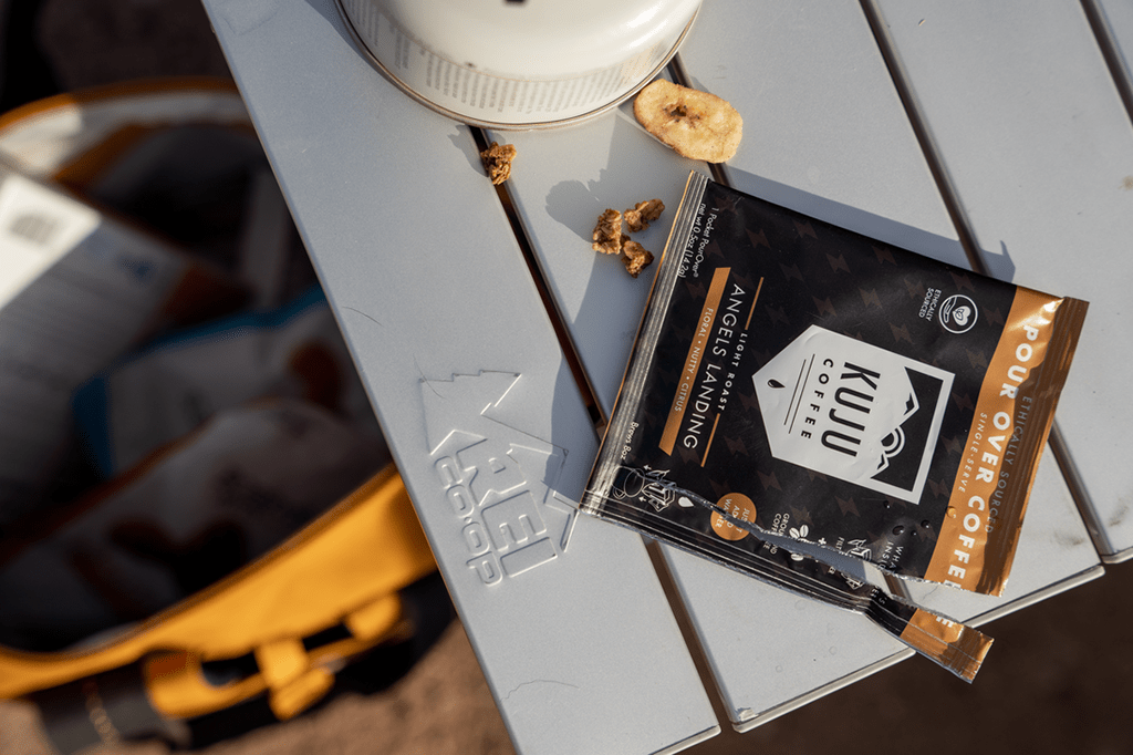 A pour-over coffee packet on a camp table