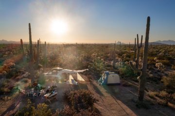 Photo of people car camping in a desert.