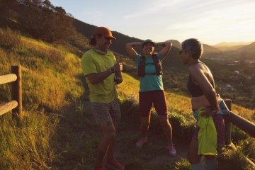 Three runners on a trail, laughing together