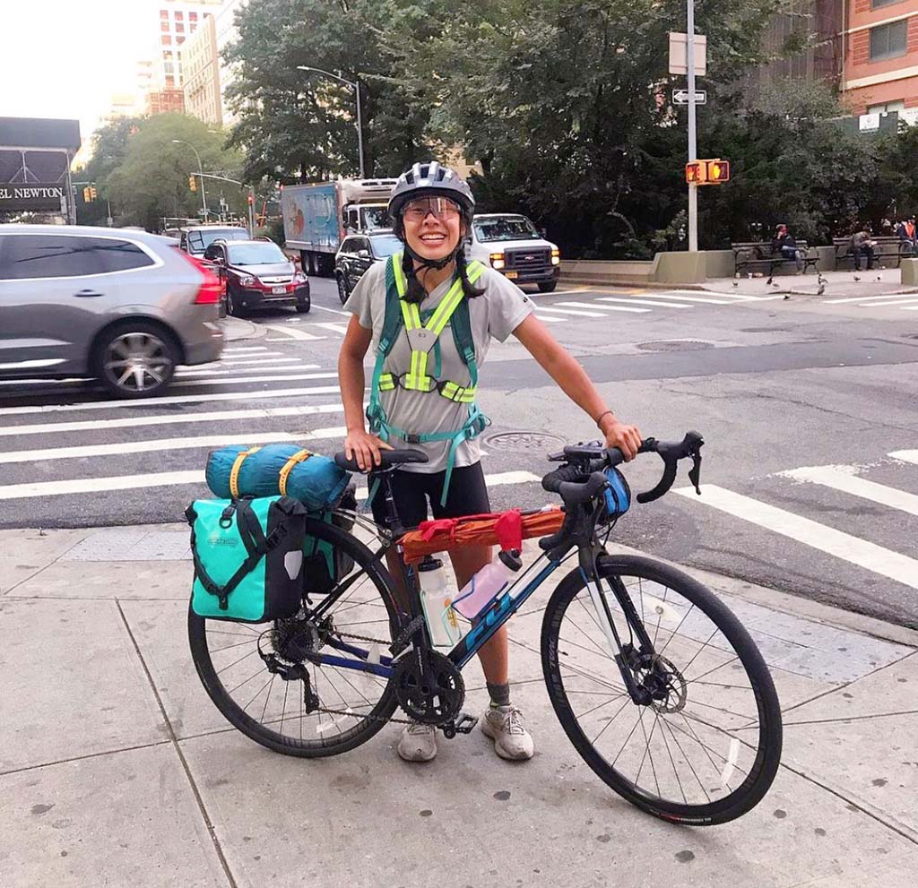 Regina Yan stands next to her bike on a corner in New York City.