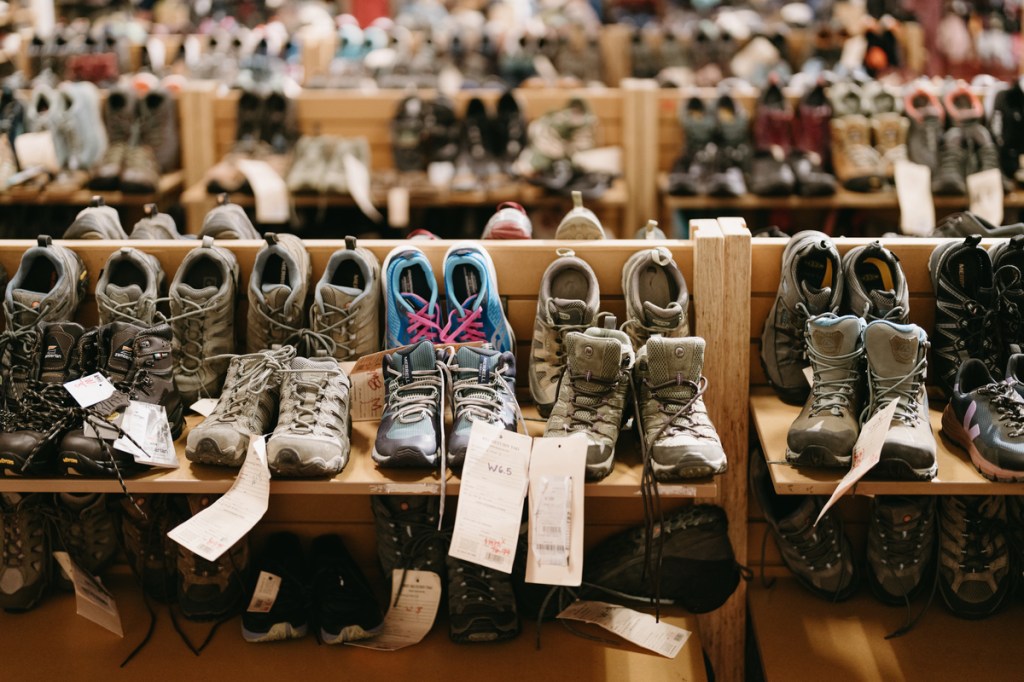 Rows of used shoes in an REI store