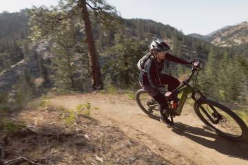 A person rides the new Co-op Cycles electric mountain bike DRT e3.1