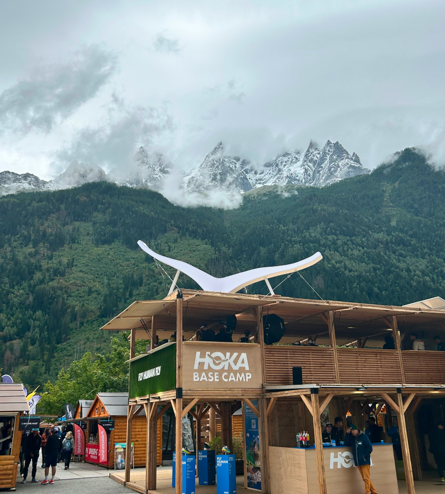 HOKA Basecamp at UTMB can be seen at the base of a mist-covered mountain.