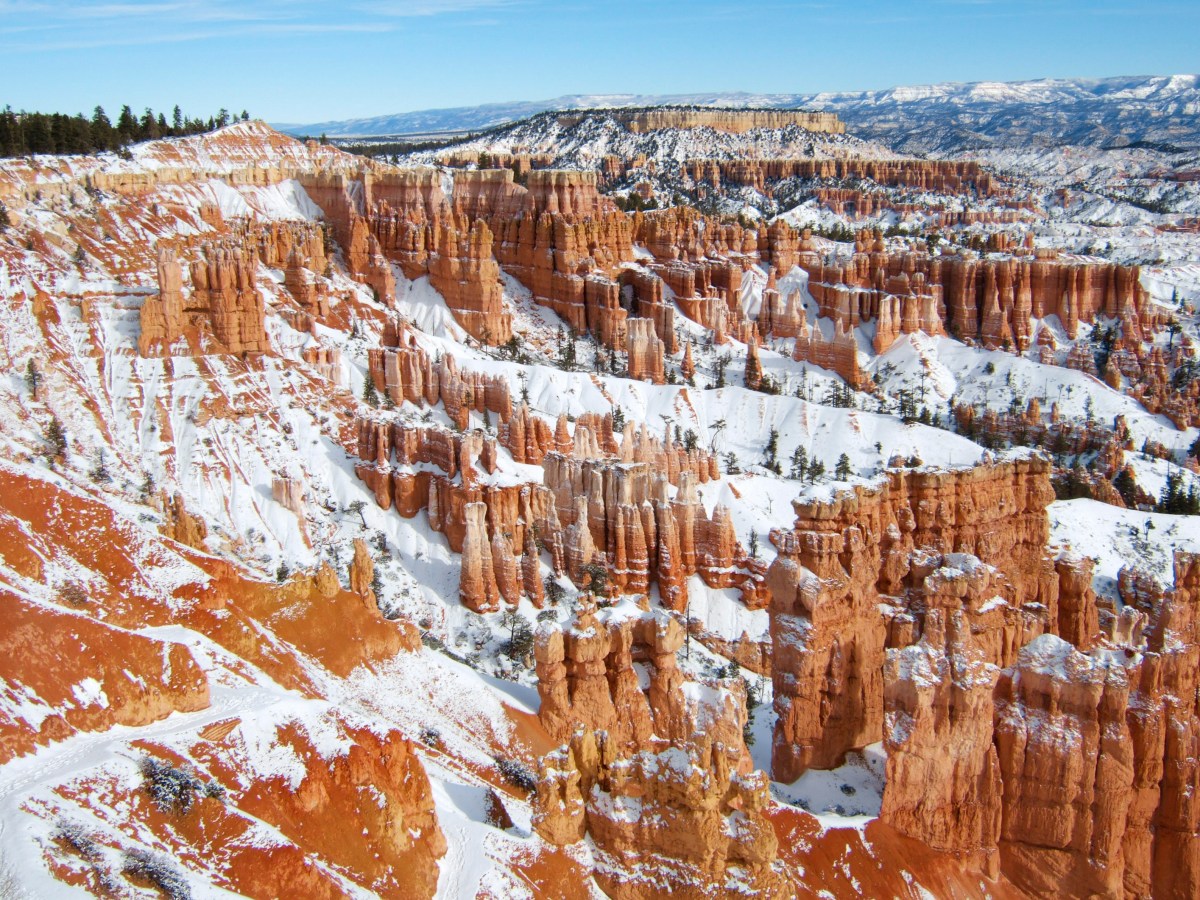 Red-rocks desert formations covered in snow.