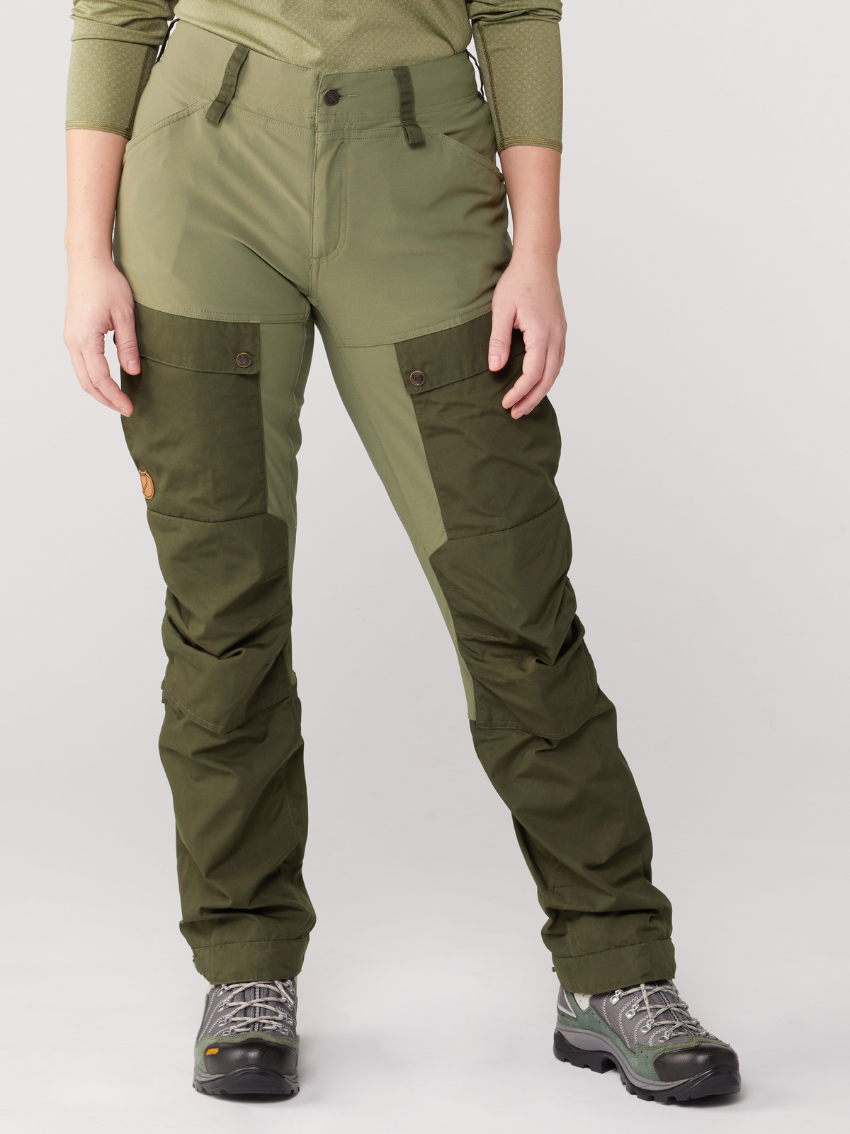 A waist-down photo of a person wearing green Fjallraven hiking pants
