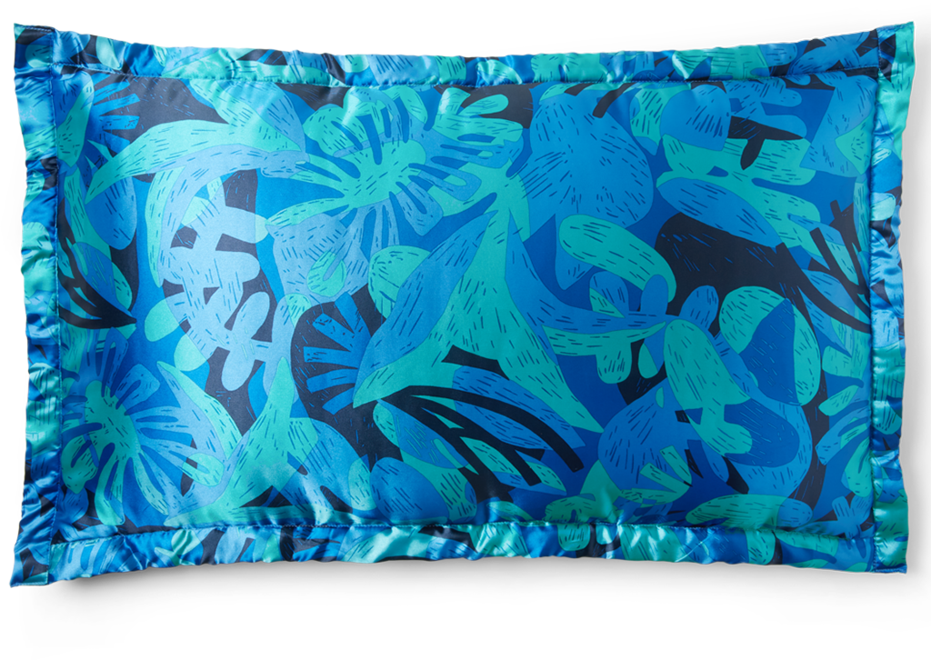 A satin pillow featuring organic shapes in a variety of blues and blue-greens.