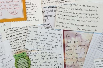 A collection of handwritten letters to REI Co-op, spread out on top of each other.
