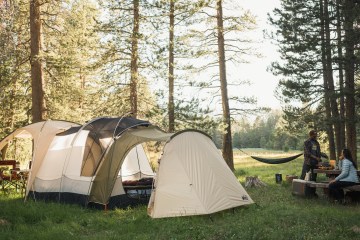 Tent and hammock in grassy campground