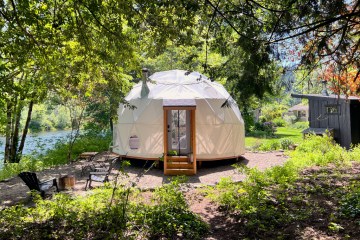 Photo of a geodesic dome in the woods.