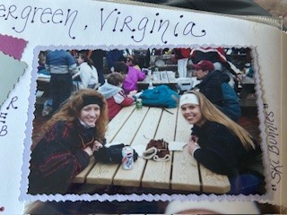 A photo of two women smiling at a camera after a day of skiing