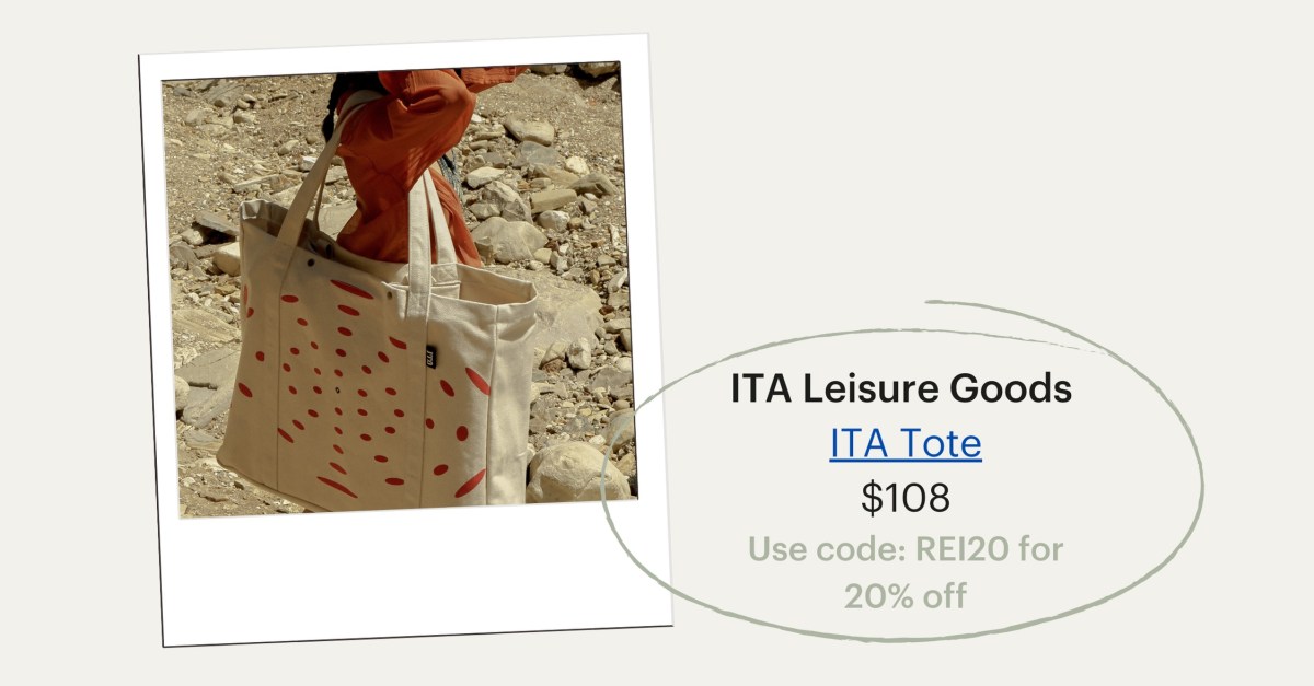 A person carries a large white tote bag with red designs on it. ITA Leisure Goods's ITA Tote, $108.