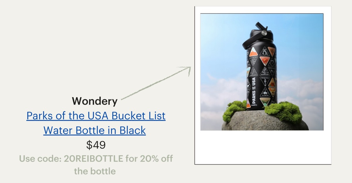 A black water bottle is featured outside perched on a rock. Wondery brand's Parks of the USA Bucket List Water Bottle in Black, $49. Use code 20REIBOTTLE for 20% off the bottle.