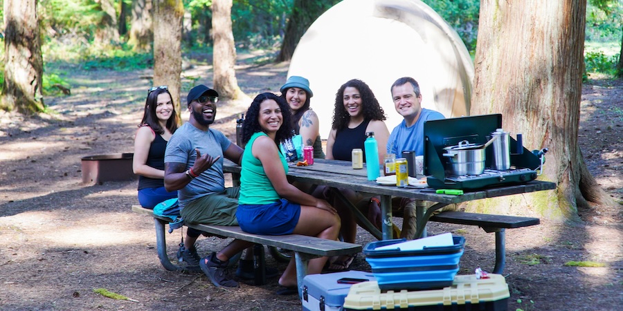 A group of friends at a picnic table.